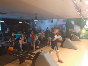 chłopiec przygotowuje się do strącenia kręgli