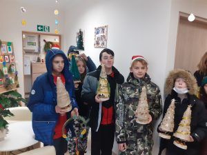 grupa uczniów z podarunkami w Domu Seniora