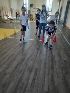 uczniowie na sali gimnastycznej podczas pokonywania toru przeszkód