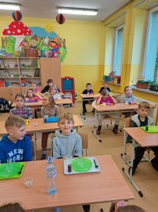 Uczniowie siedzą w ławkach podczas zajęć z Krainą Eksperymentów