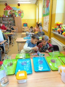 uczniowie wykonują doświadczenie