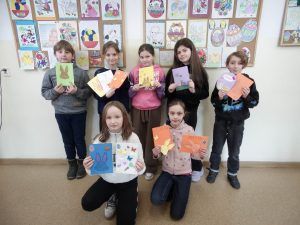 grupa uczniów z kartkami świątecznymi dla kolegów i koleżanek z Niemiec