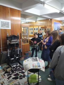 Uczniowie uczestniczą w warsztatach graficznych z wykorzystaniem prasy introligatorskiej do złoceń